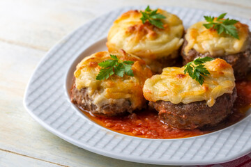 Turkish Food Hasanpasa Kofte - Kofta with Puree - Meatball with Bechamel Sauce and Green Peas. Traditional Food.