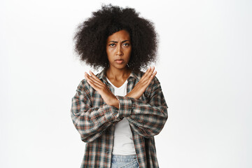Stop. Serious woman stopping, showing prohibit action gesture, showing cross, forbid smth,...