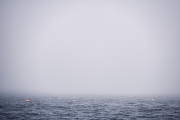 Lobster trap buoy floating on a choppy ocean in the Atlantic Ocean