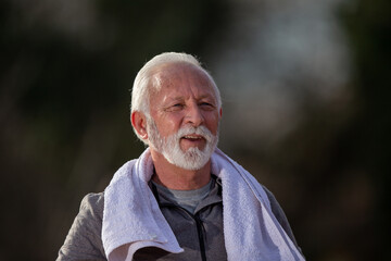 Portrait of a smiling senior man in tracksuit