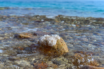 Close up of salt background. Natural salt. Dead Sea salt mineral natural formations. Salt crystals from Dead sea. View of Dead Sea coastline. Texture of Dead sea. Salty seashore rocks