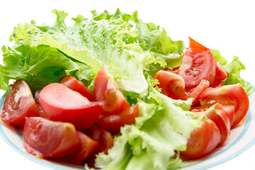 plate with tomatoes and fresh salad with water droplets frillis lettuce,