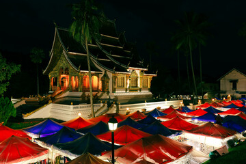 Royal Palace Museum and Famous night market at twilight in Luang Prabang, Laos. Colorful night...