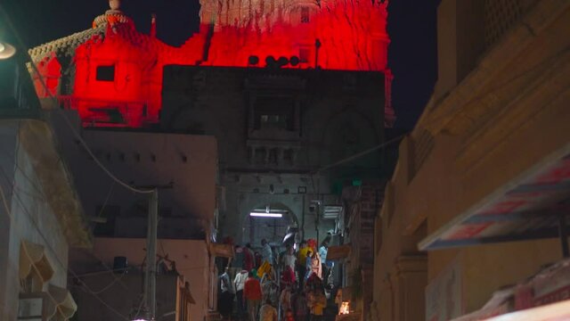 Dwarka, Gujarat, India : Circa 2021- Night view of many people at historical Dwarka temple At Dwarka. Sacred pilgrimage of Hindus in India. Concept of Faith and Spirituality of Indian people