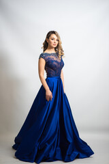 Fototapeta premium beautiful young blond woman in dress on white studio background