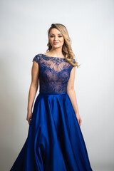 Fototapeta premium beautiful young blond woman in dress on white studio background