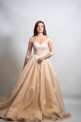 Fototapeta premium Beautiful bride perfect style. Wedding hairstyle make-up luxury wedding dress. Young attractive Caucasian model like a bride isolated on white background 