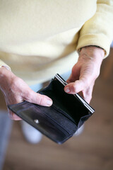 Female hands holding an empty wallet