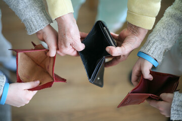 Fototapeta Three people holding an empty wallet in their hands obraz