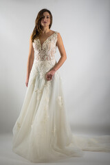 Fototapeta premium Beautiful bride perfect style. Wedding hairstyle make-up luxury wedding dress. Young attractive Caucasian model like a bride isolated on white background 