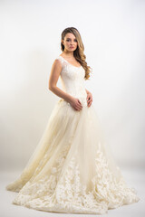 Fototapeta na wymiar Beautiful attractive bride in wedding dress with long full skirt, white background