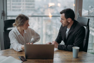Teamwork in business. Partners are discussing business issues at the table in the office.