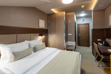 Interior of a luxury hotel double bed bedroom in the morning