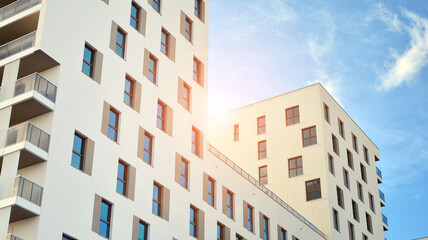 Modern luxury residential flat. Modern apartment building on a sunny day. White apartment building with a blue sky. Facade of a modern apartment building.