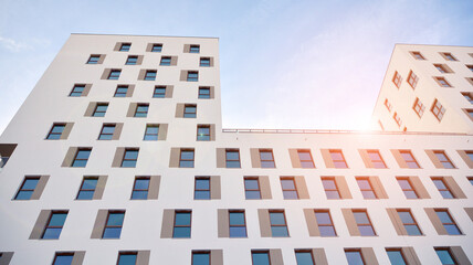 Modern luxury residential flat. Modern apartment building on a sunny day. White apartment building with a blue sky. Facade of a modern apartment building.