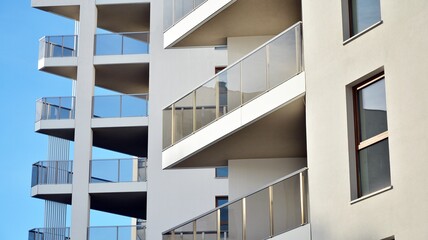 Modern luxury residential flat. Modern apartment building on a sunny day. White apartment building with a blue sky. Facade of a modern apartment building. - obrazy, fototapety, plakaty