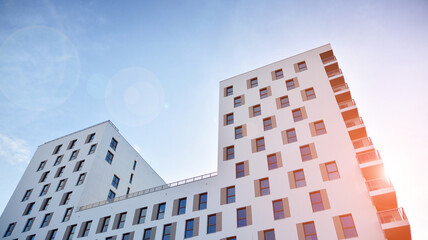 Modern luxury residential flat. Modern apartment building on a sunny day. White apartment building with a blue sky. Facade of a modern apartment building.