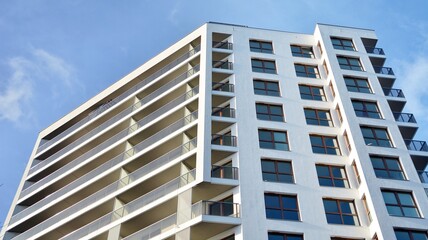 Modern luxury residential flat. Modern apartment building on a sunny day. White apartment building with a blue sky. Facade of a modern apartment building.