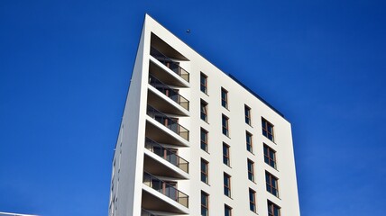 Modern luxury residential flat. Modern apartment building on a sunny day. White apartment building with a blue sky. Facade of a modern apartment building.