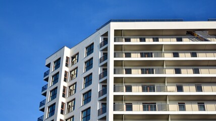 Modern luxury residential flat. Modern apartment building on a sunny day. White apartment building with a blue sky. Facade of a modern apartment building.