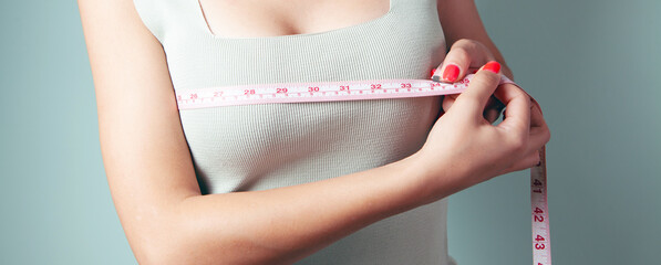 young girl measures her breasts