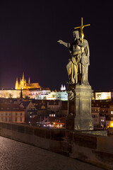 Night winter Prague Lesser Town with the gothic Castle from Charles Bridge above the River Vltava, Czech Republic