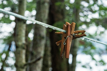 Raindrops and clothespins on a clothesline - obrazy, fototapety, plakaty