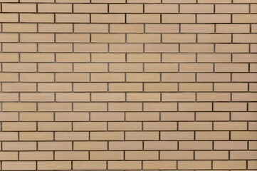 The brickwork is yellow-brown. Wall, background, texture
