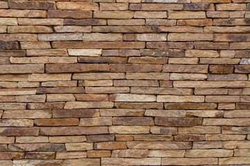 Stone masonry of flat brown stone. Background, texture