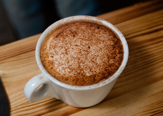 cup of coffee on wooden table in cafe