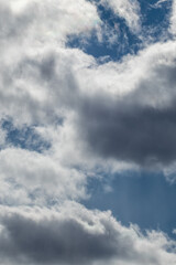 Dramatic sky clouds view texture background. Sunset high scenic layered cloudy blue heaven view. Vertical