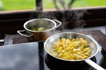 fried garlic and sweet potatoes in a skillet