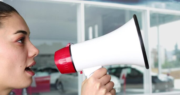 person shouting into megaphone