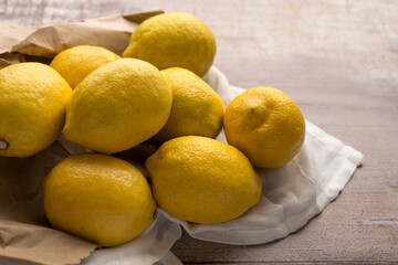 Yellow lemons on wooden table, top view