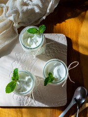 Homemade yogurt in small jars, personal portions, top view.