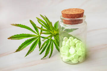 hemp extract products- prescription marijuana pills in bottle. Fresh green leaf of cannabis sativa weed. Alternative therapies, Lifestyle and treatments.