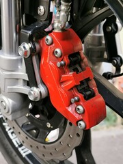 Close up image of motorcycle front brake disc system.