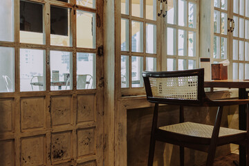 Cozy cafe interior with whitewashed decor and table for two with window view