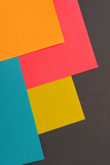 colorful paper corners on dark gray baclgrpimd