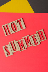 sign with the words "hot summer" in wooden stencil type on paper