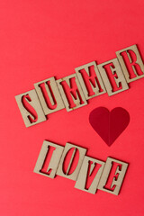 sign with the words "summer love" in wooden stencil type on paper
