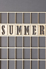 sign with the word "summer" in wooden stencil type on paper
