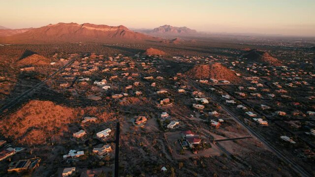 Arizona Sunset Aerial of Rural Residential Homes with Mountains in Background