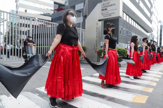 Performers stage a protest outside the offices of Spanish energy firm Repsol, in Lima