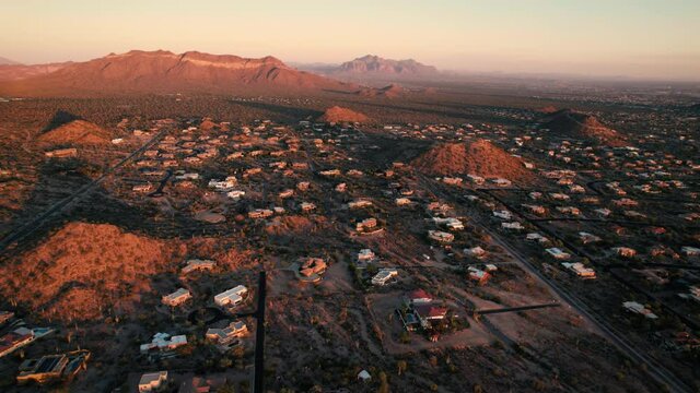 Arizona Sunset Aerial of Rural Residential Homes with Mountains in Background