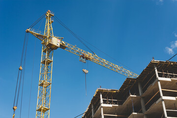 Fototapeta na wymiar Tower crane on the background of construction.