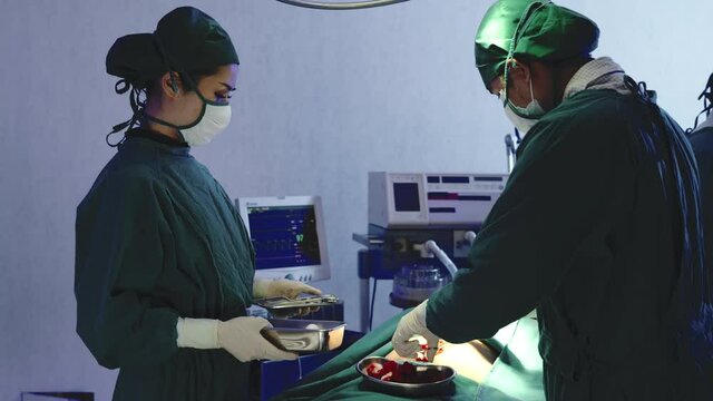 Medical surgical doctor team performing surgery patient, Group surgeon at work on operating room with electrocautery equipment for cardiovascular emergency surgery center in hospital
