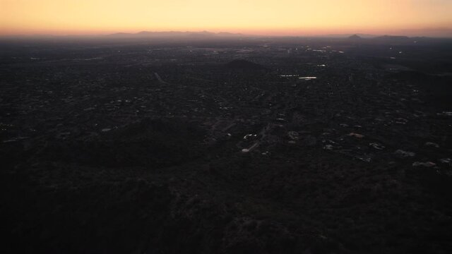 Dreamy Aerial with Atmospheric Haze Over Phoenix Suburbs and Arizona Mountains