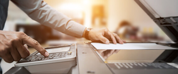 Copier printer, Close up hand office man press copy button on panel to using the copier or photocopier machine for scanning document printing a sheet paper and xerox photocopy.
