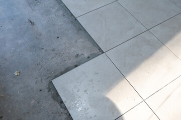 Close-up Installing tiles floor in construction work